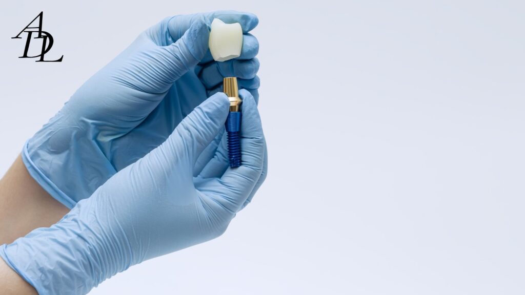 One hand holding a crown and another hand holding an implant showing it about to be put into the crown.